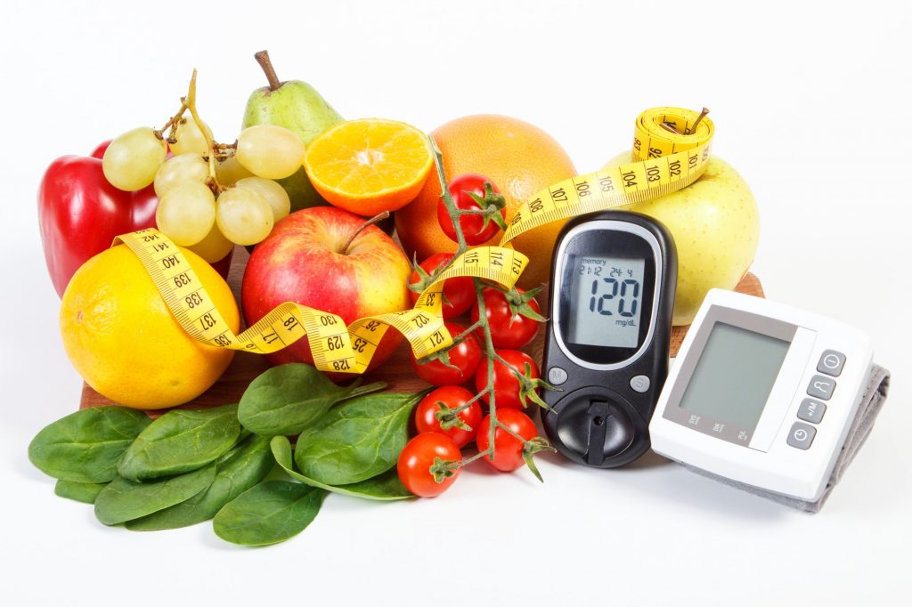 Glucometer for checking sugar level, blood pressure monitor, fruits with vegetables and centimeter